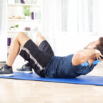 Man doing situps in living room